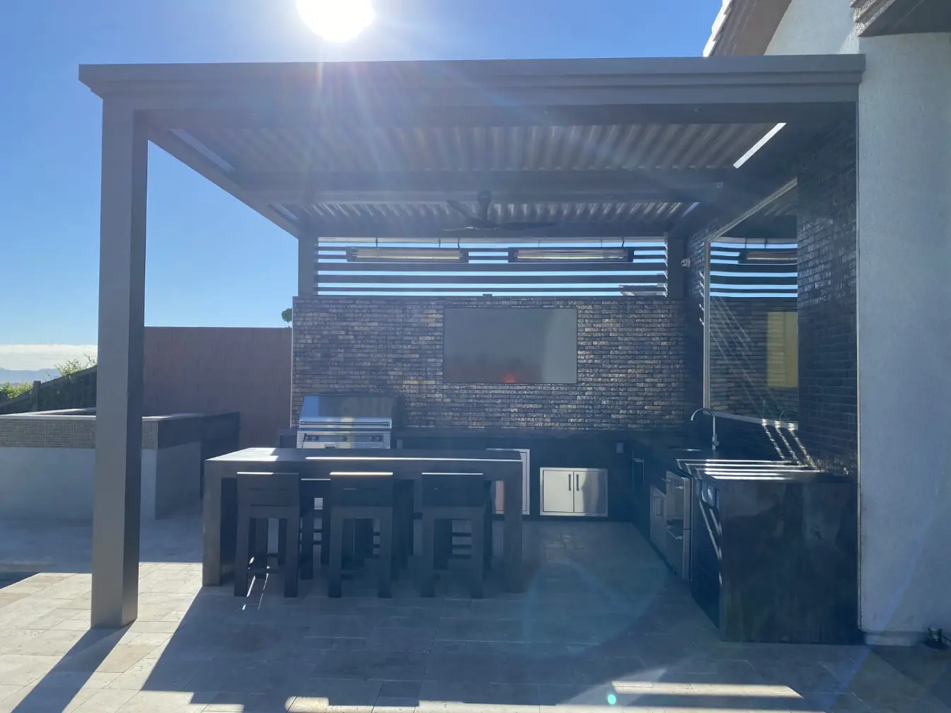 outdoor kitchen build with built in barbecue stone flooring marble countertops