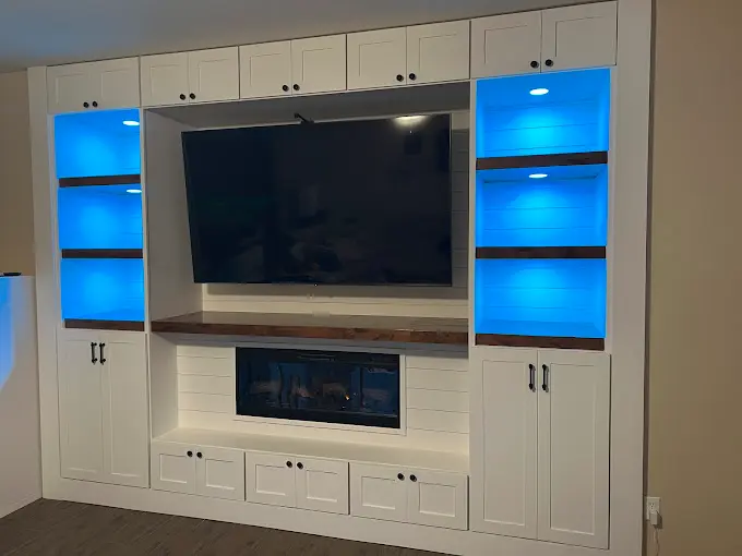 custom white entertainment center built in with accent lighting