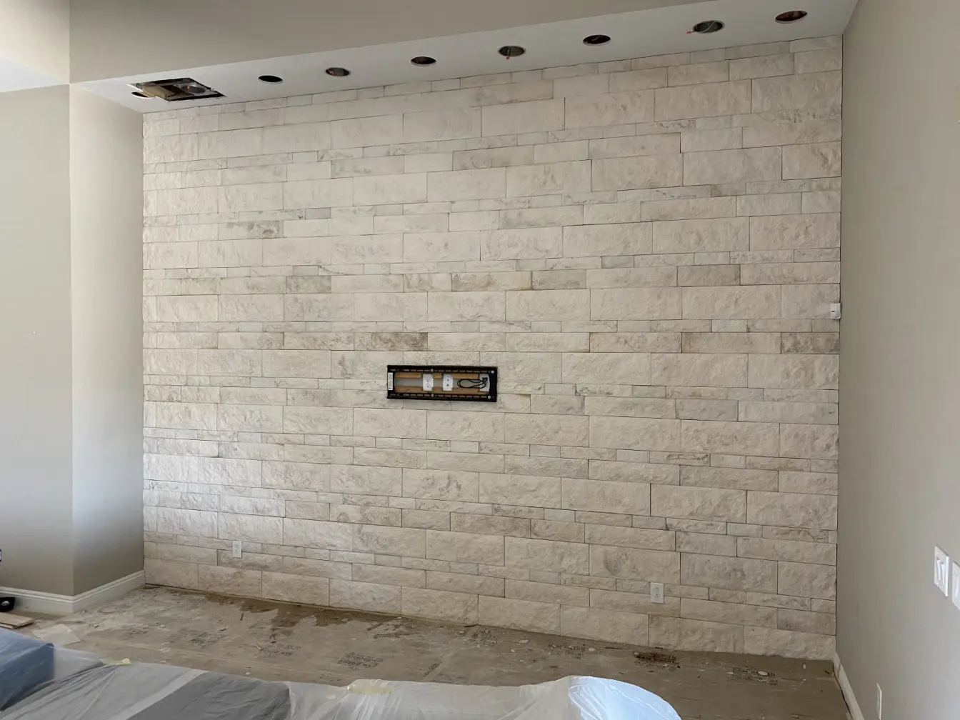 stone wall interior installation with tv mount